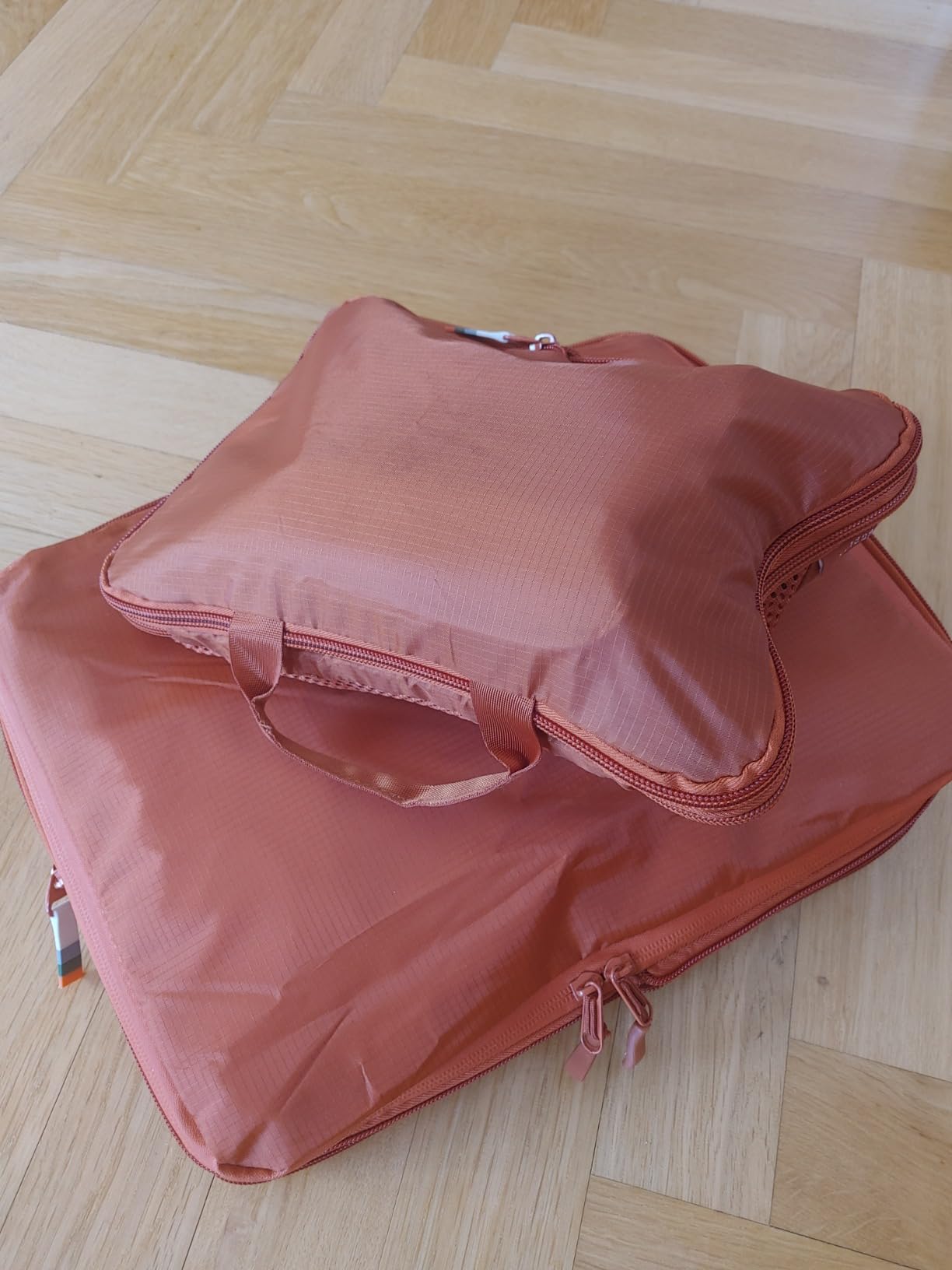 Set of red Travel Dude packing cubes for compact and efficient packing