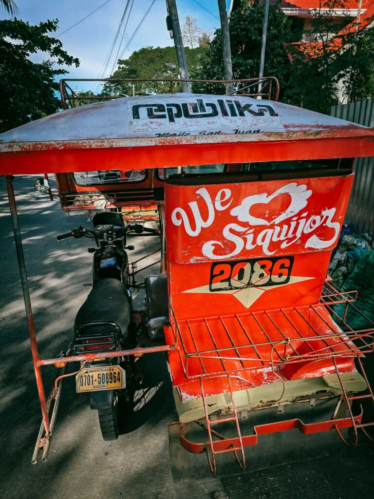Red tricycle on a street in Siquijor